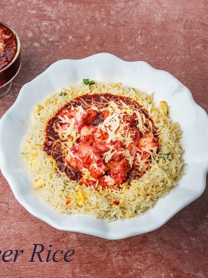 An off menu special, the Al Safeer Rice. This unique dish combines rice with a tangy gravy, our chef's special starter, and is topped with a generous amount of cheese.