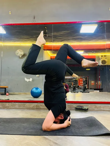 A variation of Sirsasana (Headstand) with legs in a twisted position. Inversions like this challenge your balance and bring fresh blood flow to the brain.