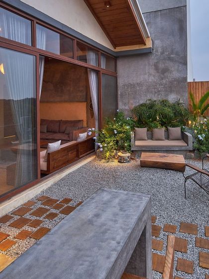 This private balcony off a bedroom is a perfect example of an intimate urban garden. We used gravel, wood-block pavers, and a custom concrete bench to create a textured, low-maintenance retreat with a strong connection to the indoor space.