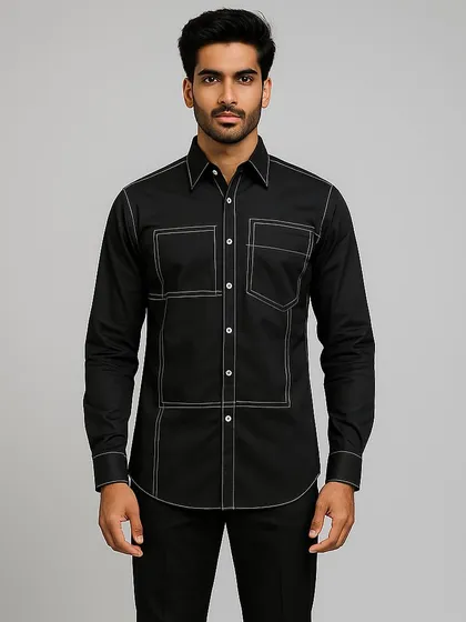 A modern take on a classic black shirt, this piece is defined by its bold geometric pattern created with thick, white contrast stitching. The design adds structure and a graphic element, elevating a simple shirt into a contemporary statement.