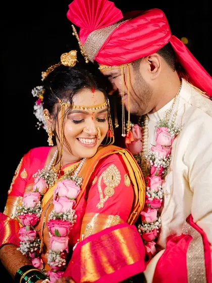 A close-up, romantic shot of the couple. The bride's subtle makeup and traditional Nauvari saree look stunning.