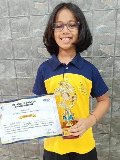 Kashvi Uchil proudly displays her silver medal from the U12 Girls Singles category.