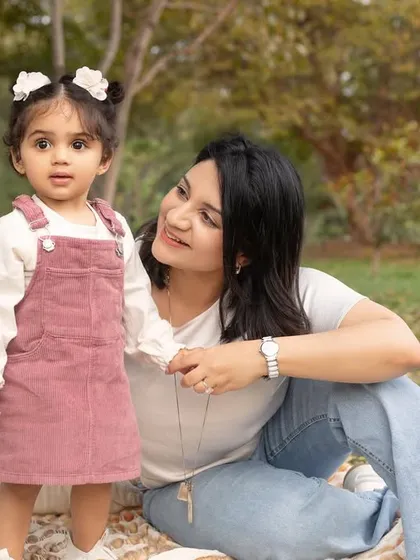 A mother and daughter sharing a quiet moment together on a picnic blanket. The natural light is so soft and flattering.