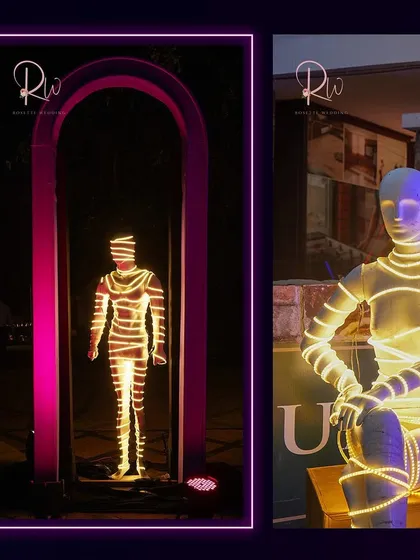 An artistic installation of mannequins wrapped in neon lights, adding a futuristic and avant-garde element to the party decor.