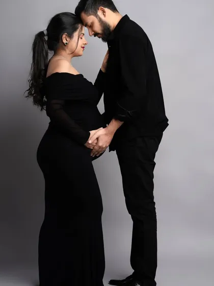 An intimate portrait in matching black outfits. This pose, with foreheads touching, creates a powerful and emotional image that symbolizes your unity and shared journey.