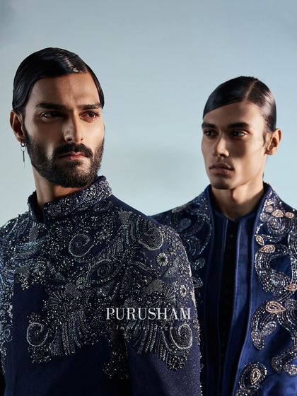 A close-up on the brilliant hand-embroidery. The mix of beads and threadwork on this deep blue jacket creates an effect that is both dazzling and irresistibly charming.