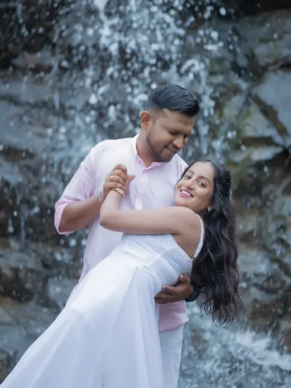 A joyful dance in front of a cascading waterfall. We love incorporating dynamic elements like water to add energy and life to your pre-wedding photos.