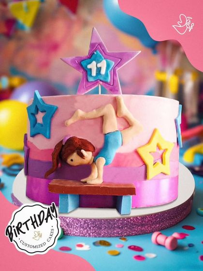 A dynamic gymnastics-themed cake for an 11th birthday. This design features a fondant gymnast, stars, and a glittery ribbon, celebrating strength and grace.