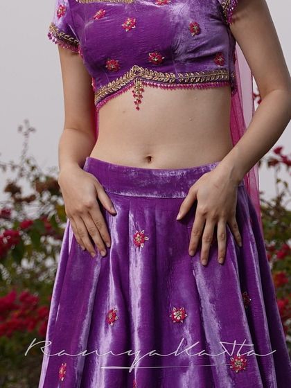 A detailed view of the 3D embossed floral embroidery on the velvet lehenga, a testament to the detailed craftsmanship.