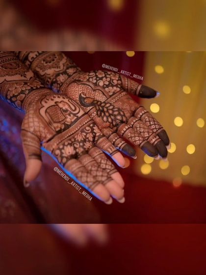 A close-up shot of a festive design with peacocks and elephants, captured against a background of beautiful bokeh lights.