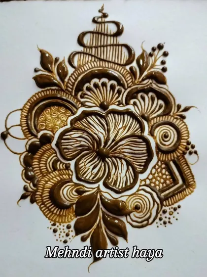 A beautiful and complex floral motif with a stacked or layered top. This is an example of a more stylized, modern element.