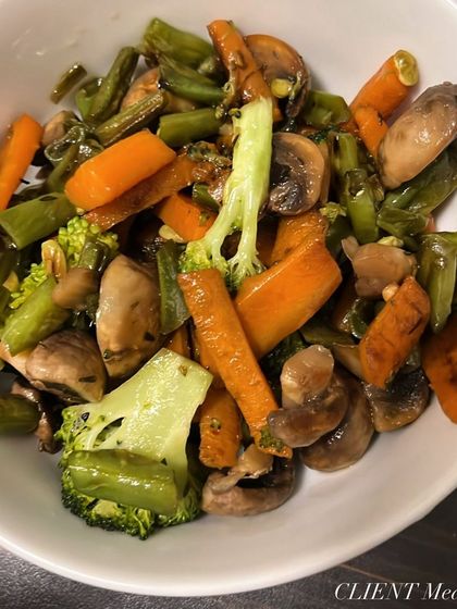 A bowl of stir-fried vegetables, including broccoli, carrots, and green beans. A simple, healthy, and satisfying client meal.