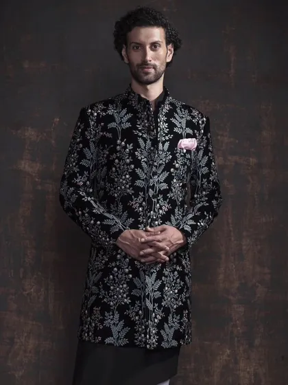 An example of modern ceremonial wear. This black bandhgala jacket is crafted from rich velvet and features intricate floral embroidery. It’s a piece that balances traditional Indian elegance with a sharp, contemporary silhouette for a truly memorable look.