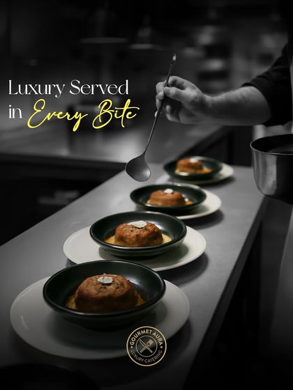 "Luxury Served in Every Bite." A chef carefully adds a sauce to a line of plated desserts, showcasing the final, delicate touches that elevate a dish.