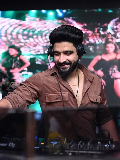 My sets are a full sensory ride. Here I am at Hex Mumbai, mixing tracks while the LED screen behind me shows dancers, creating a dynamic visual backdrop for the music.