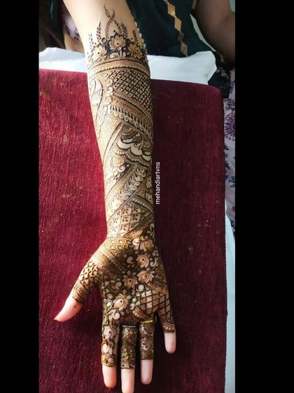 A full-arm design with a focus on flowing, organic patterns. The paisleys and vines create a sense of movement up the arm.