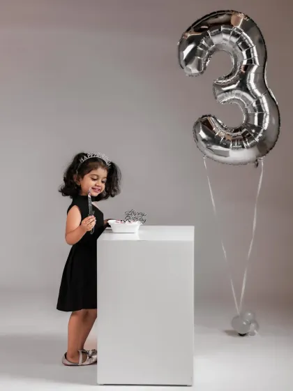 A sweet moment with her third birthday cake. We create a relaxed environment where kids can be themselves, resulting in natural and happy photos.