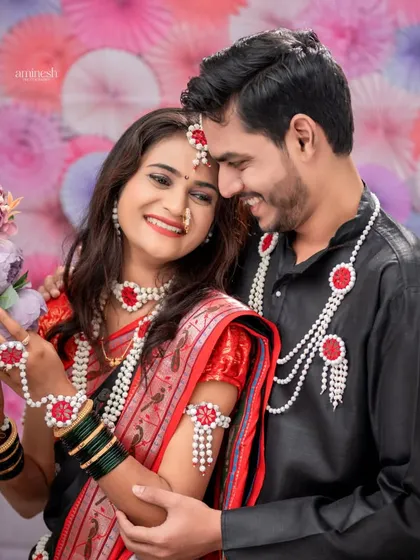 A romantic moment between a couple during their Makar Sankranti shoot. The colorful floral background adds a dreamy feel to the portrait.