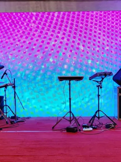 This is a stage setup designed for an awards night or corporate sangeet, complete with a full band setup. The large LED backdrop can be customized with brand visuals or dynamic graphics, while the side panels add texture and depth to the design.