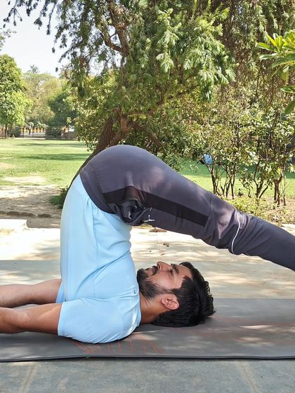 This is Halasana, or Plow Pose, an inversion that deeply stretches the shoulders and spine. I teach this to help reduce back pain and improve blood circulation.