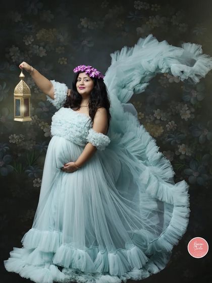Lighting the way for her little one. This creative studio portrait with a lantern adds a touch of magic and whimsy to the beautiful maternity shot.