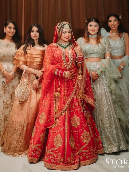 The bride with her tribe. It’s always a joy to see the bride surrounded by her best girls, all looking their best. Her central red lehenga stands out beautifully against their pastel outfits.