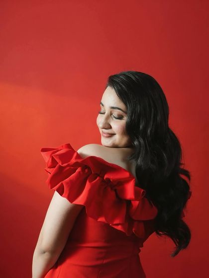 Actress Revathi Pillai looking radiant in a vibrant red off the shoulder dress for the Kota Factory screening. This look is fun, youthful, and perfect for a celebratory premiere night.