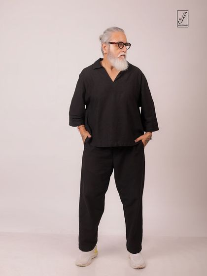 A full-length standing shot that shows the comfortable fit and modern design of the black co-ord set.