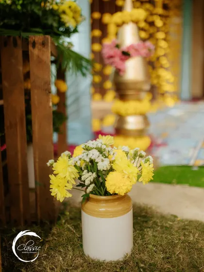 Small touches make a big difference. A simple ceramic pot with yellow chrysanthemums adds a spot of charm and continues the color theme throughout the venue.
