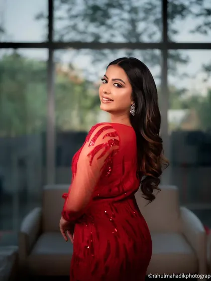 A smiling portrait of the same woman, looking back over her shoulder. This shot captures a moment of warmth and confidence, showcasing her beautiful hair and makeup.