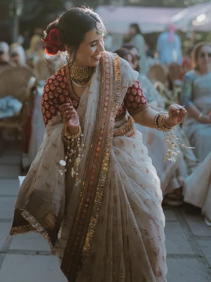 A candid shot of the bride dancing joyfully during her wedding ceremony.