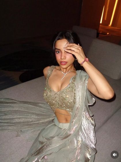 A close-up on the embellished blouse and delicate lariat necklace. This highlights how the right accessories complete the modern, sexy vibe of this drape saree.