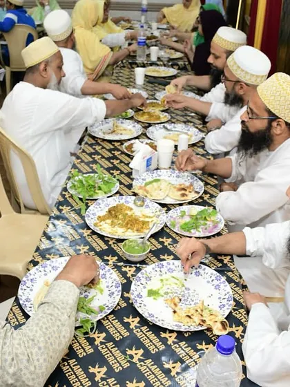 A group of men from the Bohra community enjoying a meal together. We are proud to offer a space that caters to traditional dining customs.