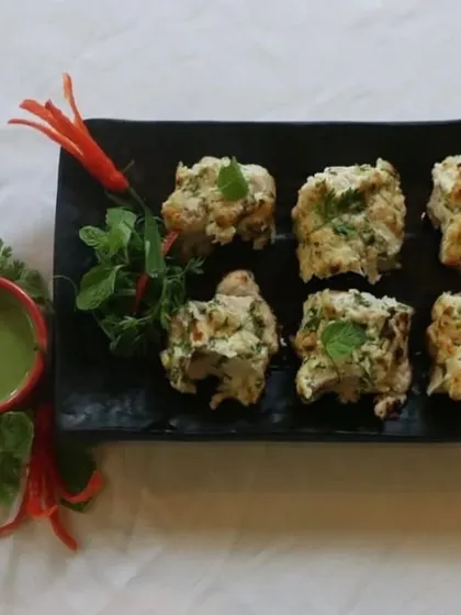 Another look at our Murgh Pudina Kalimiri Kabab, showcasing the perfectly grilled chicken pieces served with a side of our signature mint chutney.
