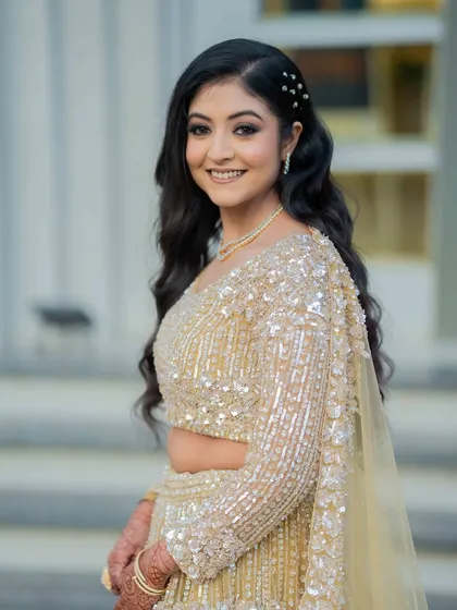 A happy, smiling bride. Her makeup looks fresh and radiant, perfect for her reception.