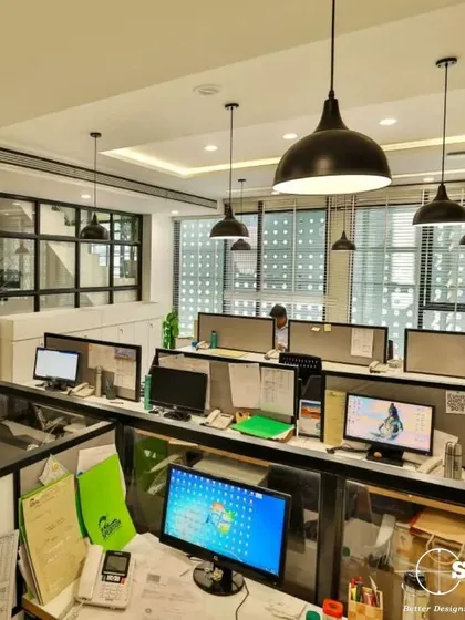 This is an open-plan workstation area designed for collaboration and efficiency. We used industrial-style pendant lighting and low-profile dividers to create a sense of community while still providing personal space for focused work.