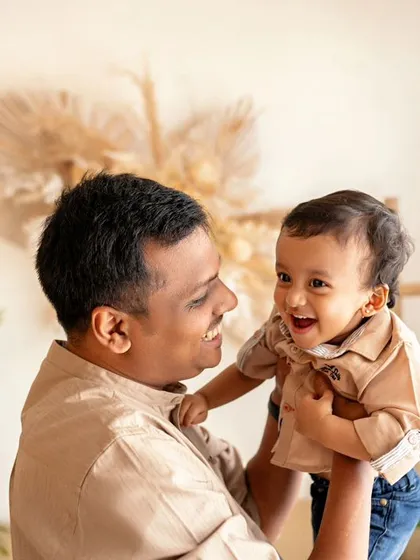 A father's love. This sweet moment of a dad holding his son is full of affection and happiness.