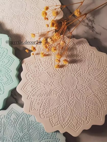 Our Mandala coasters bring a touch of intricate detail to your coffee table. This photo shows a variety of pastel shades, each with the same beautiful, calming pattern.