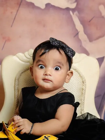 Capturing all the expressions is part of the fun. This wide-eyed, surprised look is just as precious as a smile during our travel-themed sitter session.