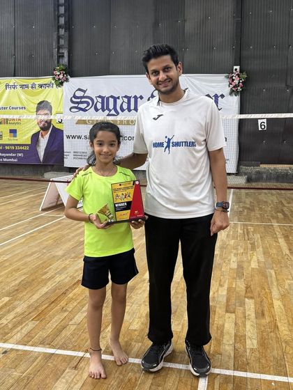 Nitika, our girls' under-11 winner, posing with her coach and award. Her consistent victories are a source of pride for the entire academy.