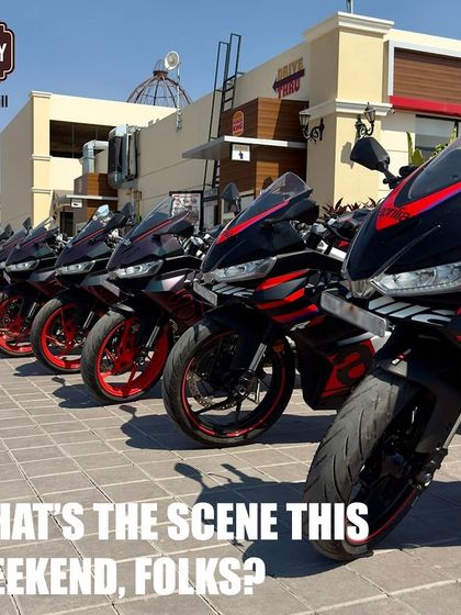 A neat row of Aprilia superbikes lined up, showcasing the community and camaraderie of a weekend riders' group meet-up.