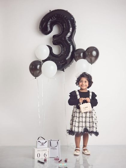 Three and fabulous. This Chanel-inspired birthday shoot is so stylish, using a monochrome palette and designer props for a high-fashion look.