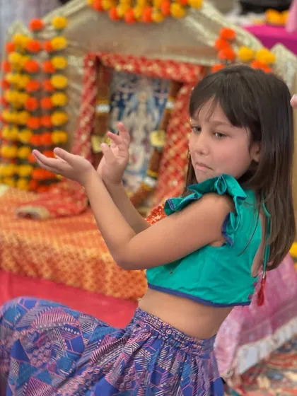 A young girl in traditional attire strikes a dance pose during our Shiva workshop at the Dayton temple. We always include music and movement in our sessions.