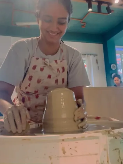 A student smiling with pride as she masters a large form on the wheel. This is the moment of triumph that makes all the practice worthwhile.