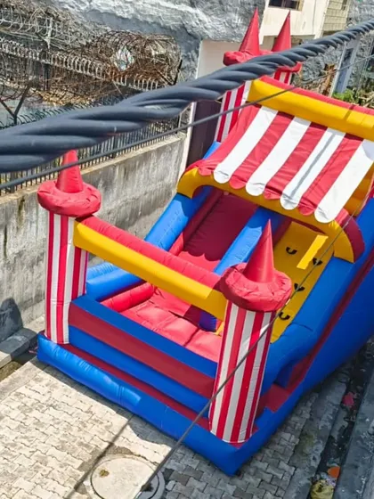 This circus tent-themed inflatable slide is a fun and unique design. The red and white striped awning gives it a classic carnival look.