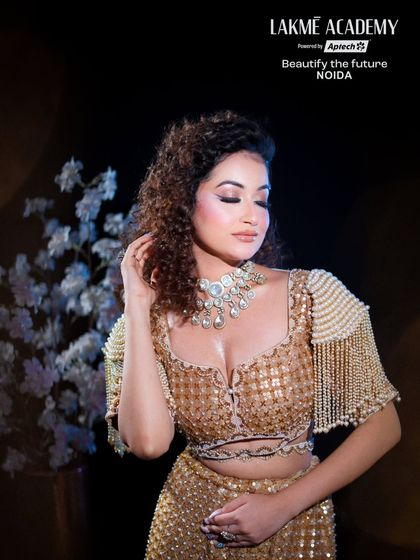 The complete look, with voluminous curls and a statement necklace, shows how we teach our students to style the entire presentation for a glamorous event.