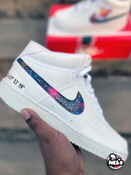 A hand-held view of the cosmic high-top, showing the personalized coordinates on the heel.