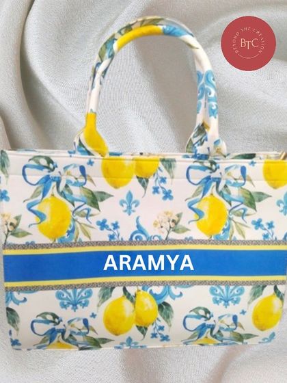 This lemon-print canvas tote bag just screams summer. It's a fresh and fun design that we can personalise with your name.