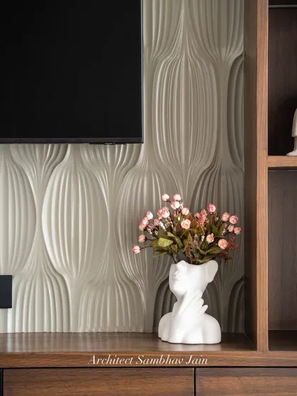 A perfect interplay of form and finish. The rich PU paneling adds a refined sheen, while the 3D textured wall brings depth and dimension. Accented with warm wood tones and curated decor, this setup balances minimalism with character.
