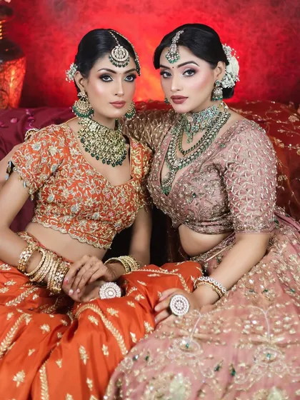 Two models showcasing complementary bridal looks for a photoshoot. This demonstrates our team's ability to create a cohesive vision for bridal parties or campaign shoots.